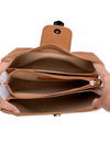 Brown leather clutch bag held open by hands on a white background