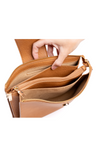 Brown leather handbag with open compartments on a white background